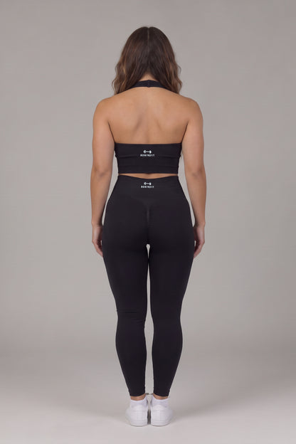 Back view of the black CAROLINA SET open-back halter top and scrunch leggings with Bonive Fit logo