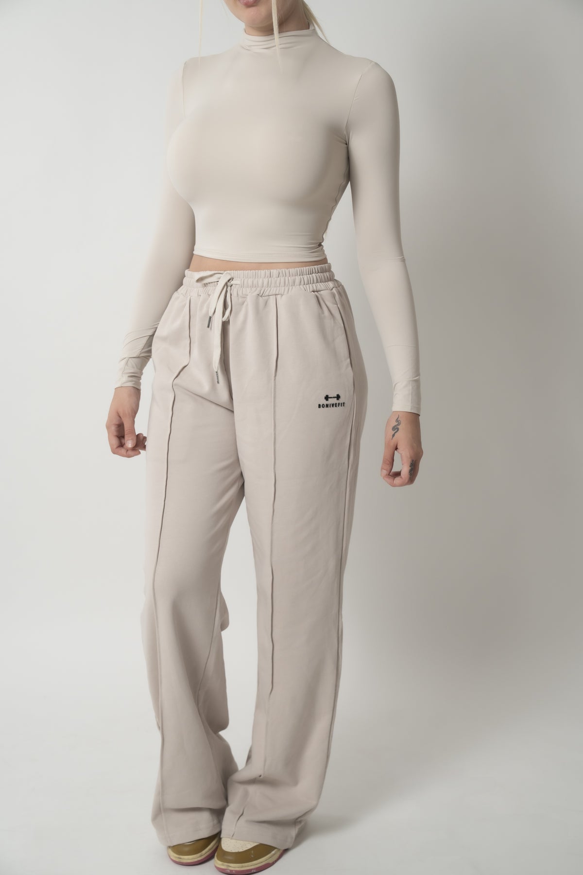 Beige DURA TOP, long-sleeve mock-neck crop top, full length, front view