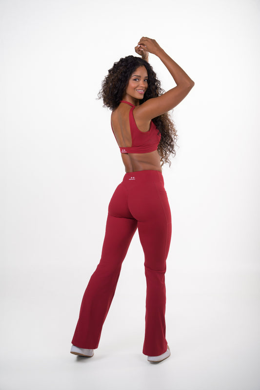 Burgundy VELVET SET, V-neck sports bra and high-waisted flare pants, back view, open back and logo on the band