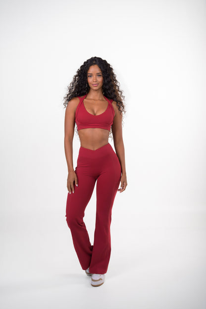 Burgundy VELVET SET, V-neck sports bra and high-waisted flare pants, front view, mid-step